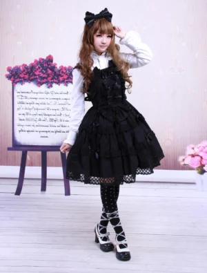 black sleeveless gothic lolita jumpskirt dress full front view polka dot stockings ruffled tiered skirt
