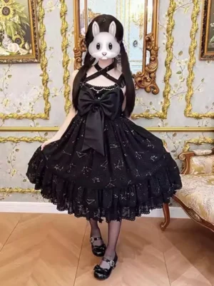 Black star constellation sweet lolita dress with criss-cross halter neckline and voluminous ruffled lace hem, front full-body view on model wearing twin-tails