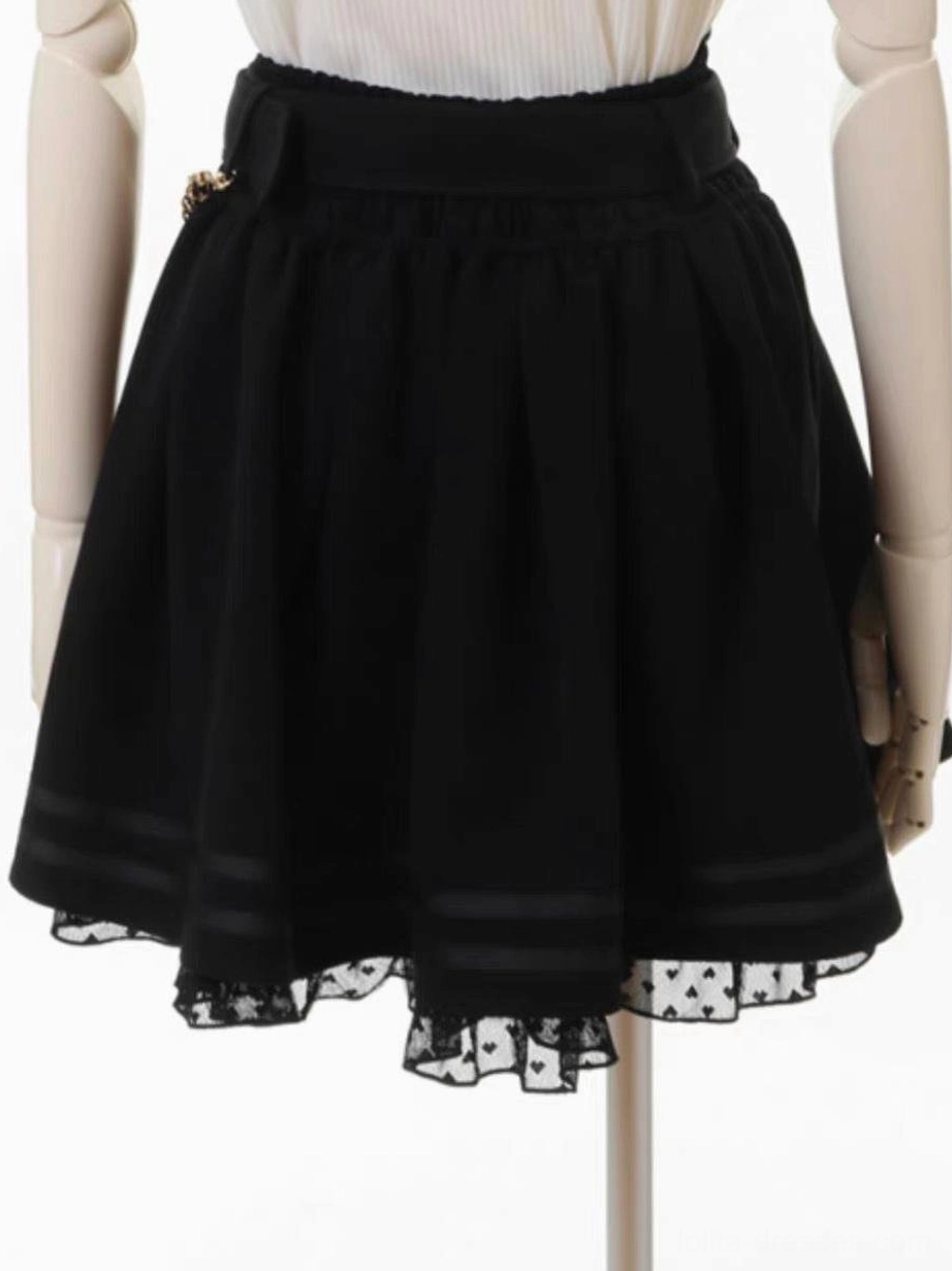 Black gothic lolita skirt side view showing striped hem trim, polka dot lace underskirt, structured waistband, grommet and chain embellishment details