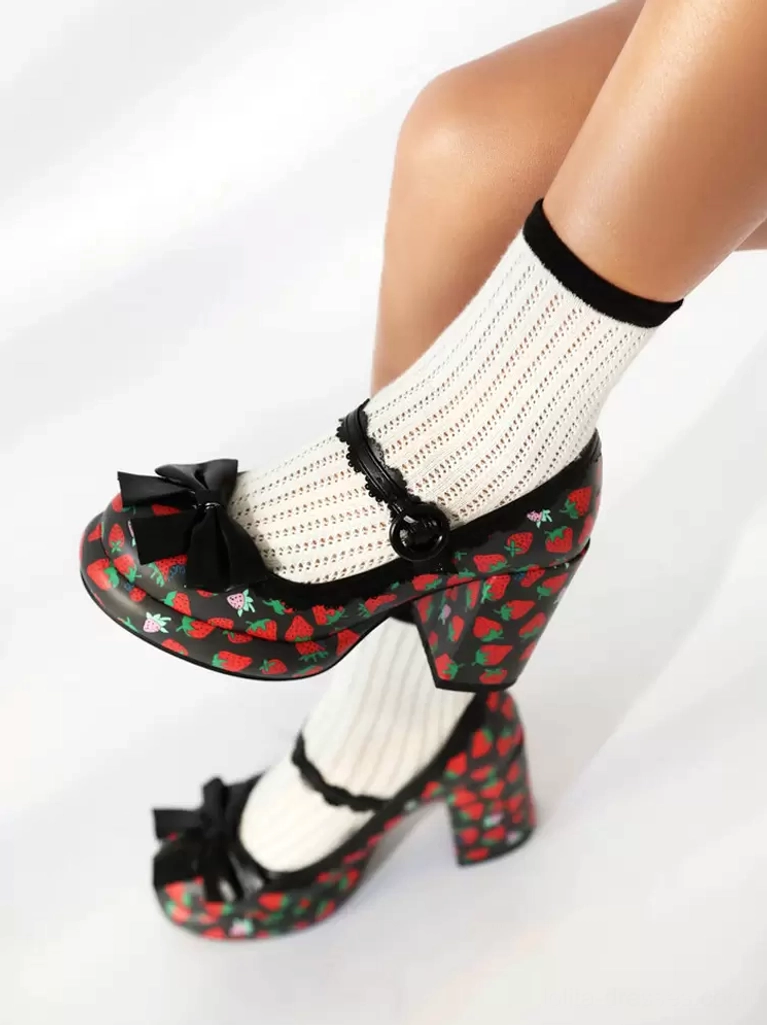 Black base strawberry lolita pumps with red strawberry print, black front bow and ankle strap, top pair view on white background