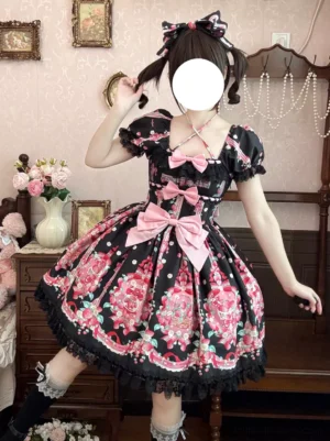 Black strawberry sweet lolita dress with pink bows front three-quarter view on model vintage bedroom setting