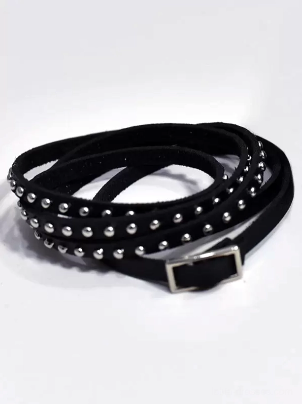Flat lay top view of black PU leather studded wrap bracelet on white background, featuring silver metal rivets and rectangular metal adjustment buckle, gothic lolita accessory detail