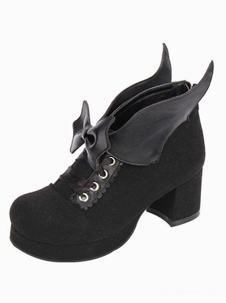Black suede Gothic Lolita chunky heel pumps with bat wing bow detail, single shoe front-side view showcasing round toe and platform block heel