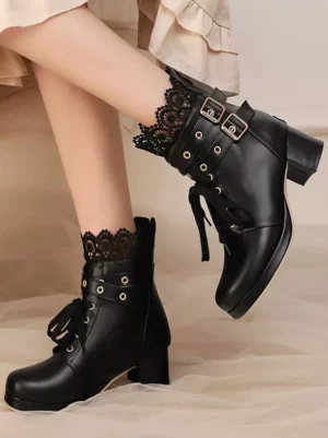 Black sweet lolita ankle boots with bow embellishments and chunky block heel, side angle view showcasing round toe design paired with delicate lace frill socks