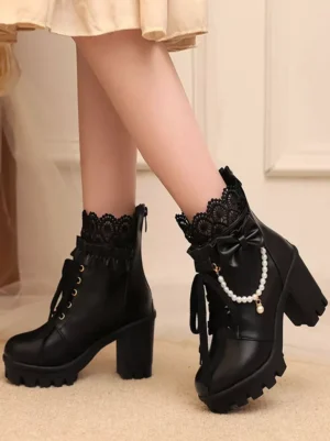 Black sweet lolita ankle boots with lace collar and pearl chain bow detail side front view on model