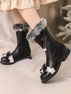 Black sweet lolita mid-calf boots with grey faux fur trim and pearl tassel bows, modeled with nude stockings and beige mini skirt, dual side-front view