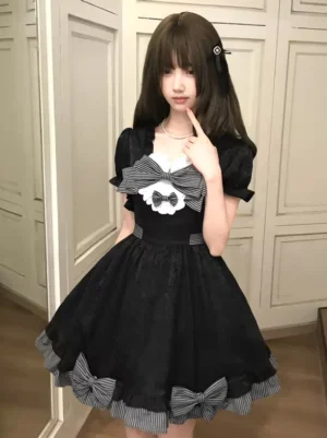 Black sweet lolita sundress front medium shot square ruffled neckline with large front bow and textured black fabric details