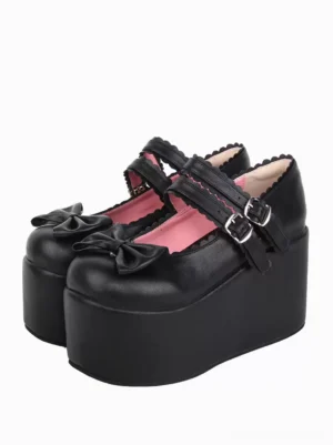 Black sweet lolita platform Mary Jane shoes with double buckle straps and bow embellishment on toe cap, three-quarter front view