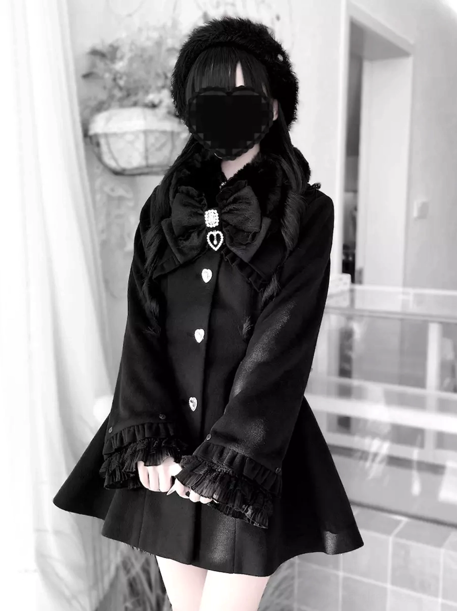 Black Sweet Lolita overcoat medium full front model view with lace-trimmed cuffs, closed collar bow, and heart-shaped decorative buttons