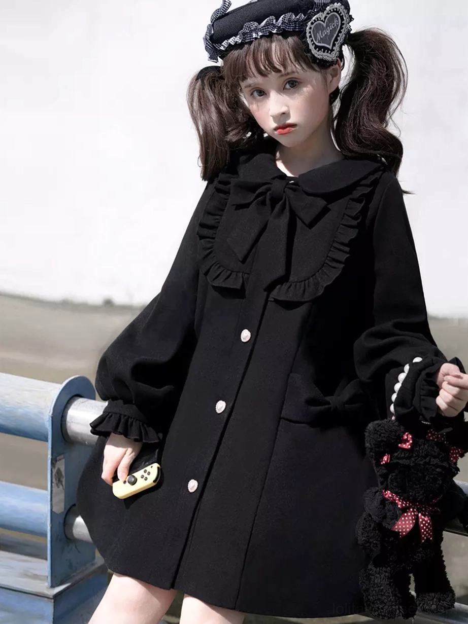 Black sweet lolita overcoat full-length view showing peter pan collar, fabric bow, ruffled details, and gothic lolita styling potential