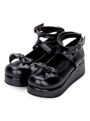 Black Sweet Lolita platform pumps with bow embellishment and dual crisscross ankle straps, three-quarter side view showing toe bow detail and thick platform sole on white background