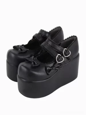 Black PU leather Sweet Lolita platform pumps front three-quarter view with heart buckles bow decorations and scalloped trim details