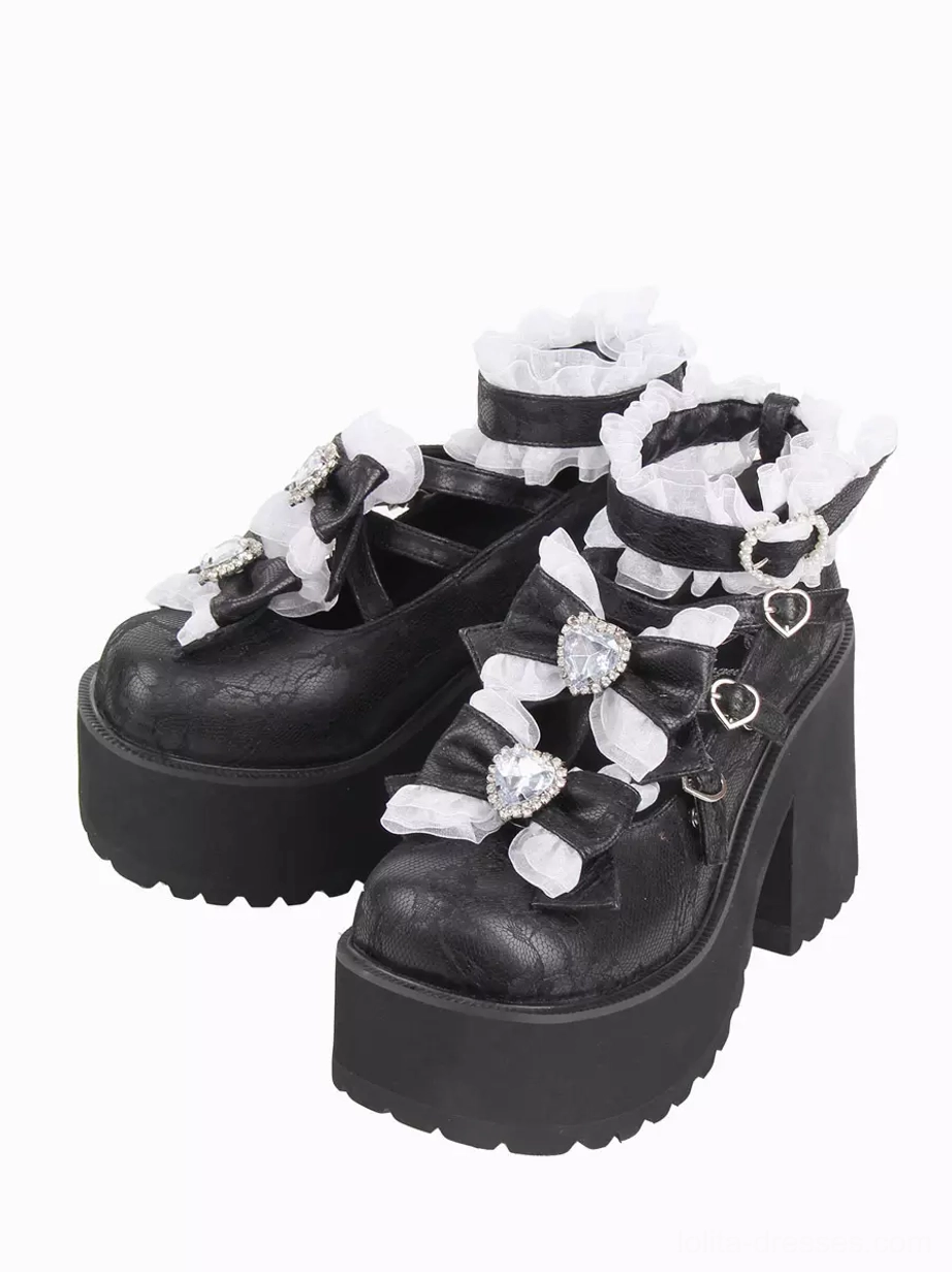 Black sweet lolita platform pumps with white ruffled ankle straps and rhinestone heart bow embellishments front three-quarter view