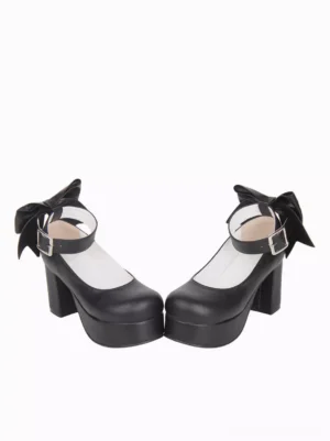 Black lolita shoes side profile showcasing thick block heel structure and large fabric back bow detail with ankle strap