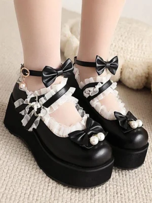 Black Sweet Lolita platform wedge pumps with pearl bow decorations and lace frills, side-front close-up shot featuring round toe silhouette and ankle strap details worn with nude stockings