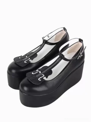 Black T-strap platform wedge Lolita shoes paired front three-quarter view showing matte PU leather upper with heart-shaped buckle detail and thick platform sole