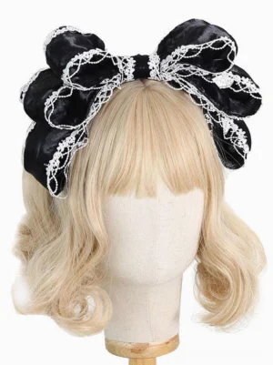 Black velvet oversized lolita bow headband with white lace trim - sweet rococo lolita headdress front view on blonde wig mannequin