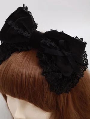 Black velvet lolita headbow with delicate scalloped lace trim close-up view showing ribbon bow accent and luxurious cotton velvet texture on mannequin