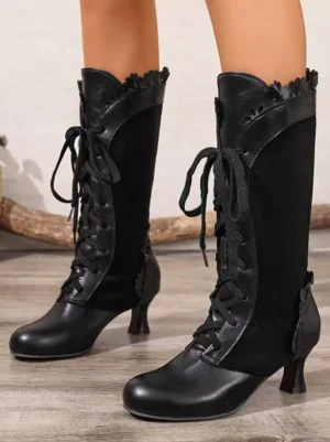 Black vintage Lolita mid-calf boots front double-feet model display featuring lace-up front, scalloped boot collar, and low kitten heel on wooden floor