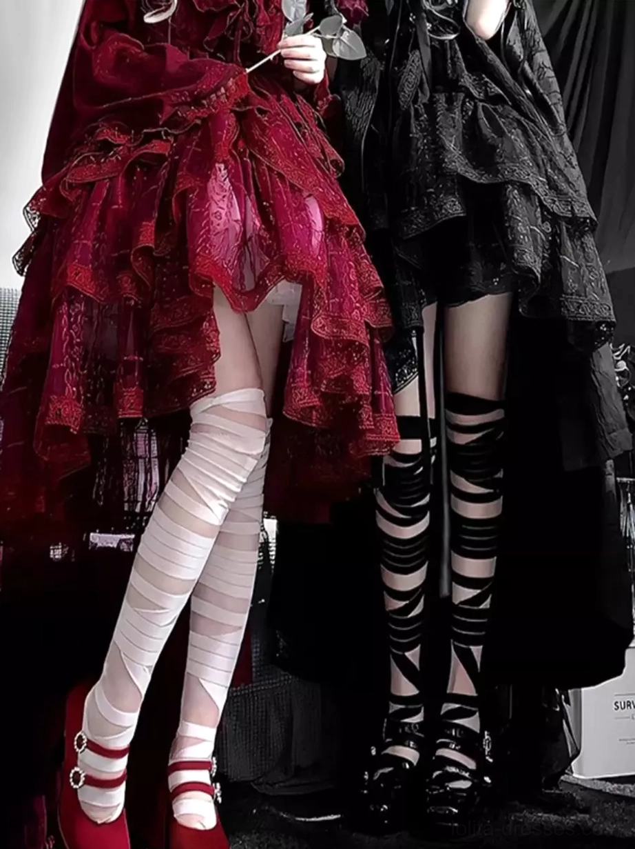 Black and white bandage lolita socks worn with gothic platform footwear, showing full thigh-high coverage and Y2K aesthetic