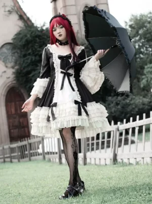 Black and white gothic lolita dress with tiered ruffles and long sleeves front view worn by model