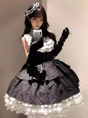 Black and white gothic lolita sleeveless tiered ruffle corset dress worn by model in three-quarter view, featuring multi-layer white ruffled neckline with black bow, black velvet gloves, quilted textured skirt with layered lace trim