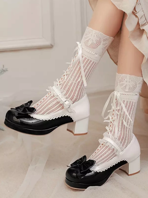 Black and white Lolita Mary Jane pumps oblique side view featuring black toe bow decoration, block chunky heel, white Mary Jane buckle strap with white lace ribbon socks