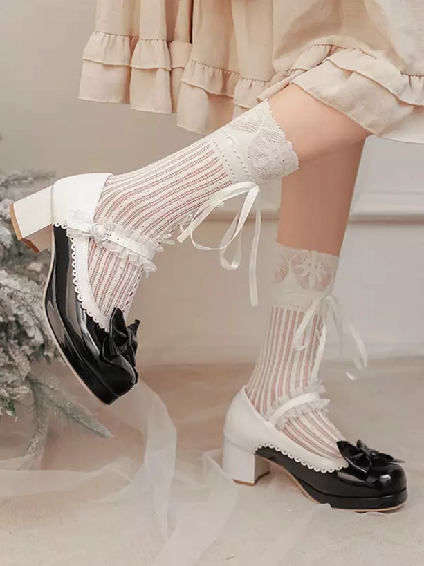 Black and white Lolita Mary Jane chunky heel pumps side profile showing bow decoration, block heel, and adjustable buckle strap with white lace ribbon socks