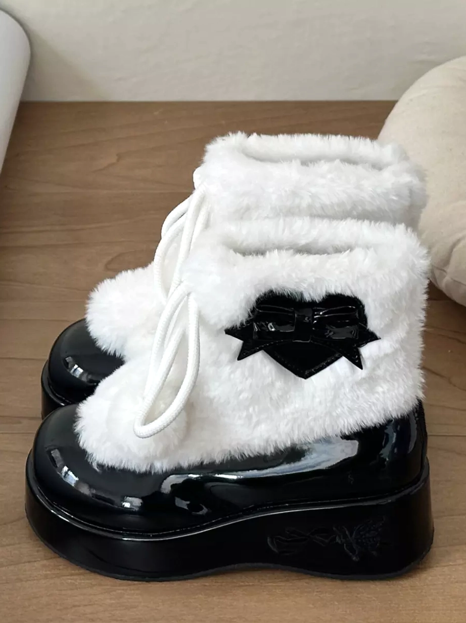 Black and white lolita platform boots with black heart bow decoration and white plush upper side view