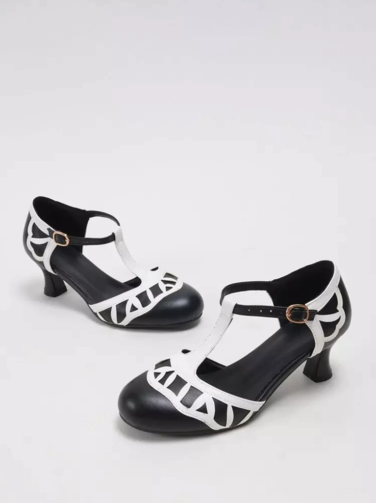 Black and white sweet Lolita T-strap pumps flat lay display, showcasing geometric cutout patterns, round toe design, and overall silhouette