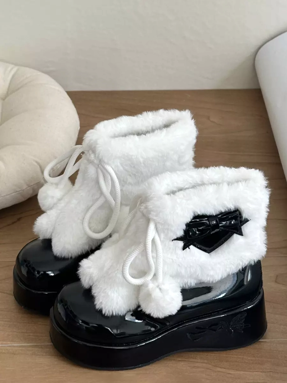 Black and white lolita winter platform boots with black heart bow and pom-pom drawstring front-side view