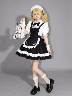Black and white sweet maid lolita dress with puff sleeves, ruffled apron, and statement bow neckline, styled on model holding plush rabbit