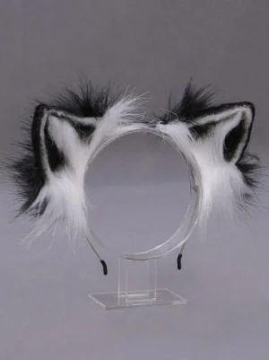 Black and white two-tone fox ear Lolita headdress displayed on clear stand, flat lay product photography showing pointed ear shape and fluffy plush texture