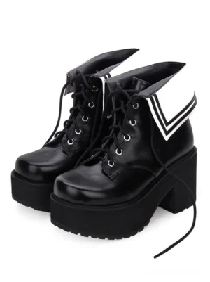 Black and white two-tone classic lolita platform boots with lace-up closure and fold-over collar, front three-quarter view showing chunky block heel and round toe silhouette