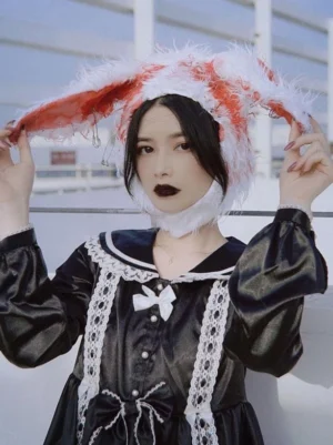 Bloody rabbit ear Gothic Lolita headdress half-body front view outdoors model adjusting hat with lace sailor collar dress white bow ornament