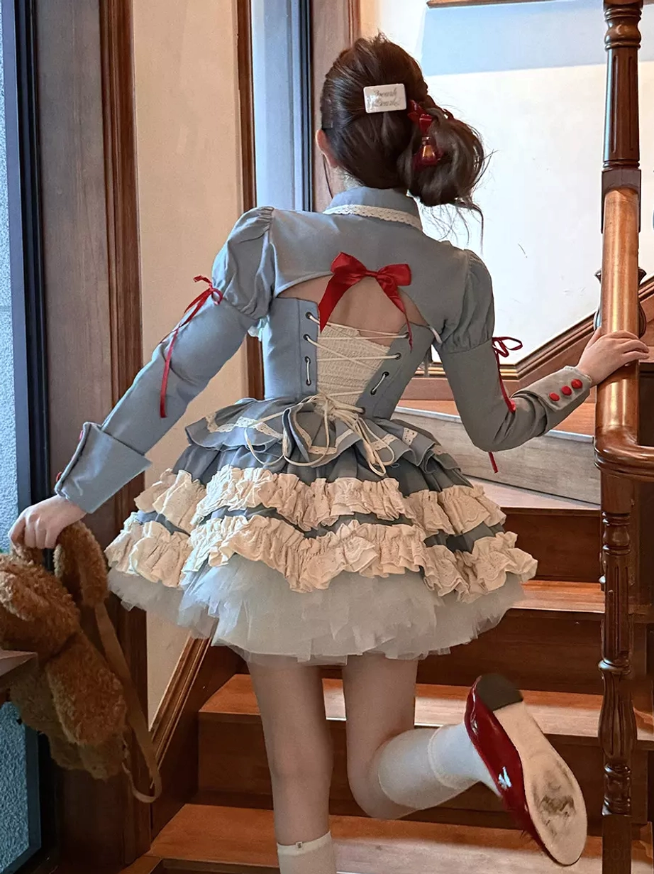 Back view of blue ballet lolita dress showing layered ruffle construction, overcoat details, and rear silhouette of the three-piece classical lolita outfit