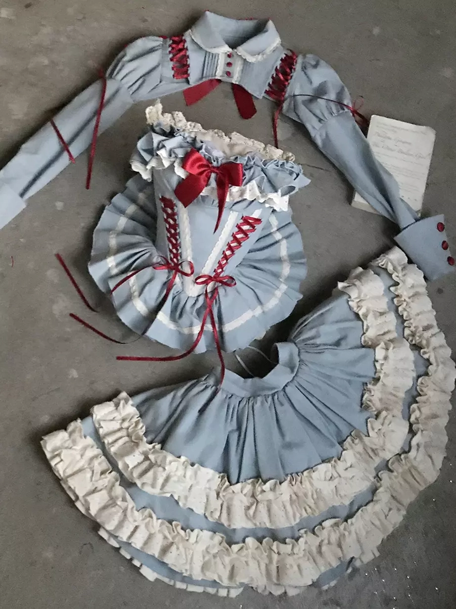 Full-length portrait of model wearing blue ballet lolita dress with coordinated styling including shoes, socks, and accessories demonstrating complete fairy dress aesthetic