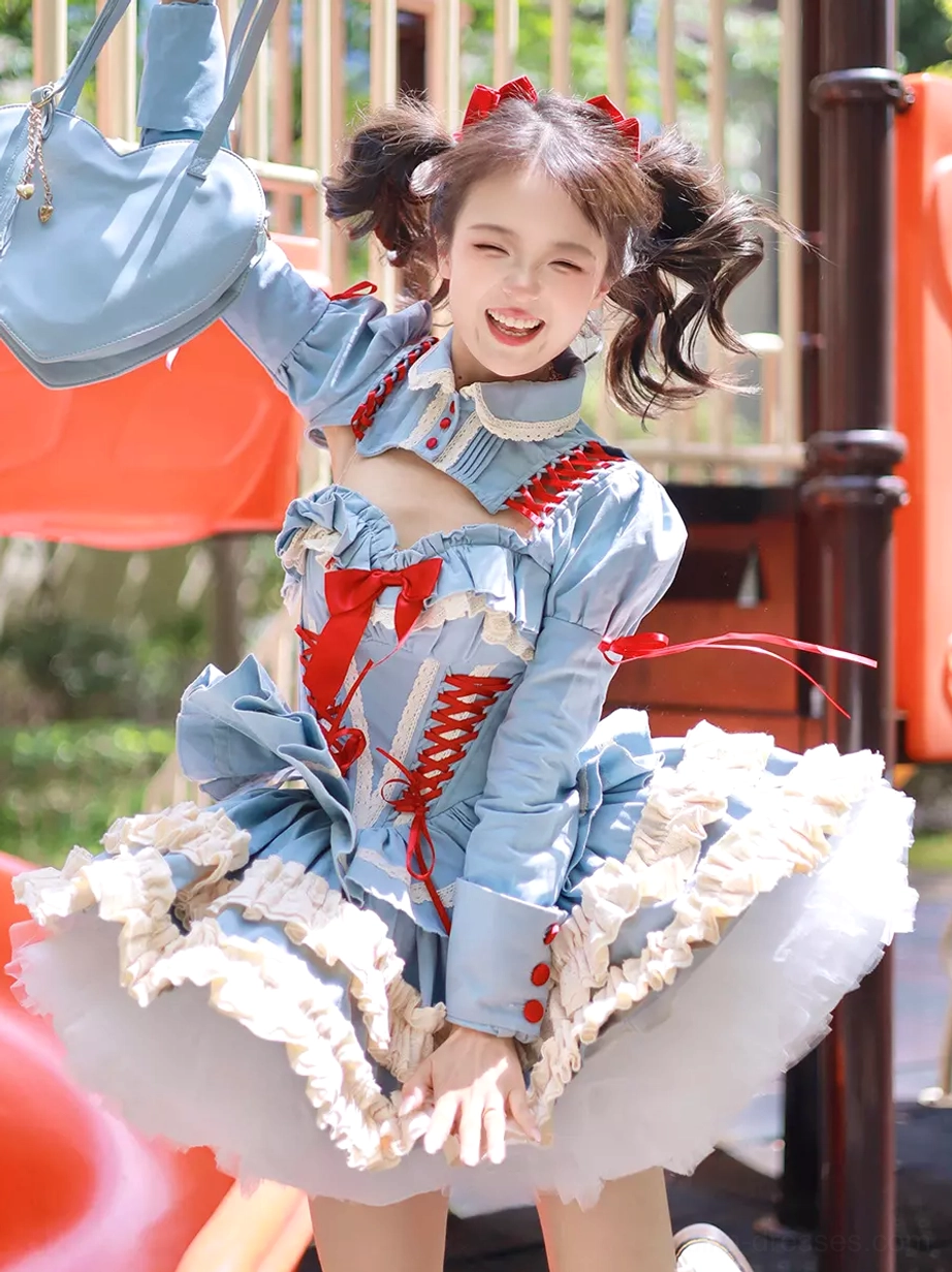 Long-sleeve variant of ballet lolita dress with front raising-arm view in outdoor park setting, featuring cutout stand collar, red lace details, and coordinating blue handbag