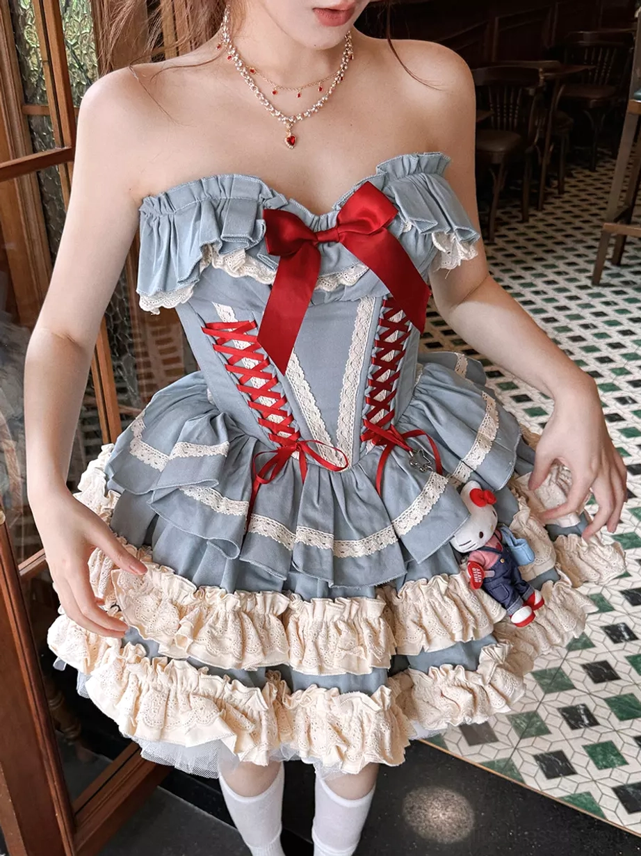 Blue ballet lolita dress detail shot highlighting red bow corset lace-up construction and embellishment craftsmanship of the three-piece ensemble