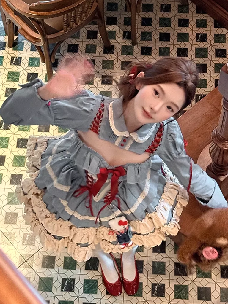 Overhead flat lay or arrangement shot of blue ballet lolita dress set components including dress, overcoat, top, and coordinating accessories for styling