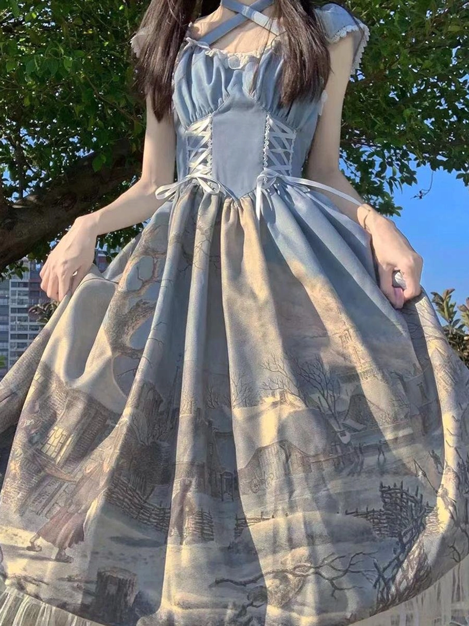 Blue landscape print classic lolita dress with cross shoulder straps and lace-up corset front, full circle skirt with ruffles, back three-quarter outdoor view under tree