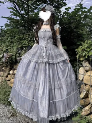 Blue lace-up fairy sweet lolita dress rear three-quarter view showing corset back, layered tulle skirt, and lace trims on garden setting