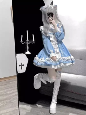 Full body side view of blue gothic lolita princess gown with layered ruffled skirt, long puff sleeves, model wearing cat ear wig and platform boots with lace thigh highs