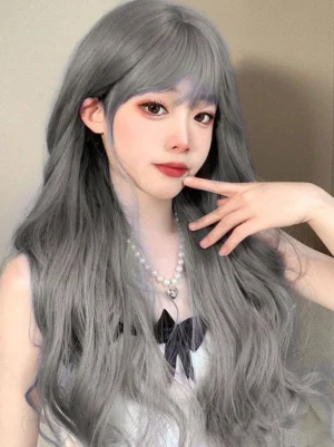 Three-quarter front view of blue-gray Lolita wig with flowing waves and air bangs, model hand pose near face displaying wig styling