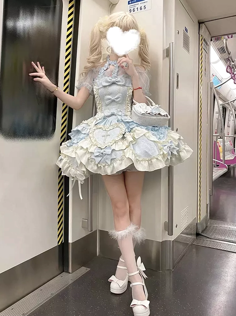 Blue lolita ballet dress side standing subway scene blonde twin-tail model touching door with coordinating handbag