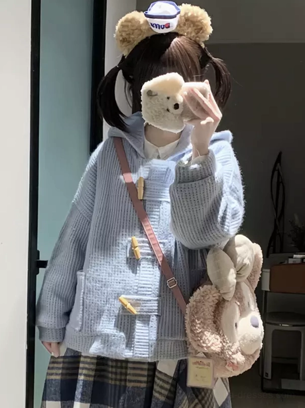 powder blue lolita hooded coat with horn buttons and waffle knit texture worn with bear ear headband and crossbody plush bag oblique view