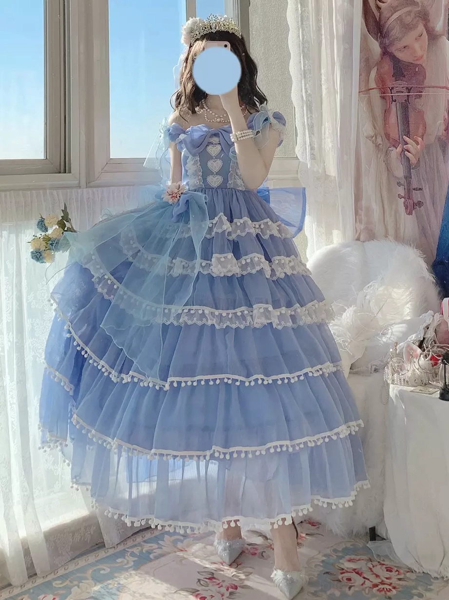 Blue lolita wedding dress featuring tiered tulle skirt, white lace trim details, and off-shoulder straps with tiara - indoor studio