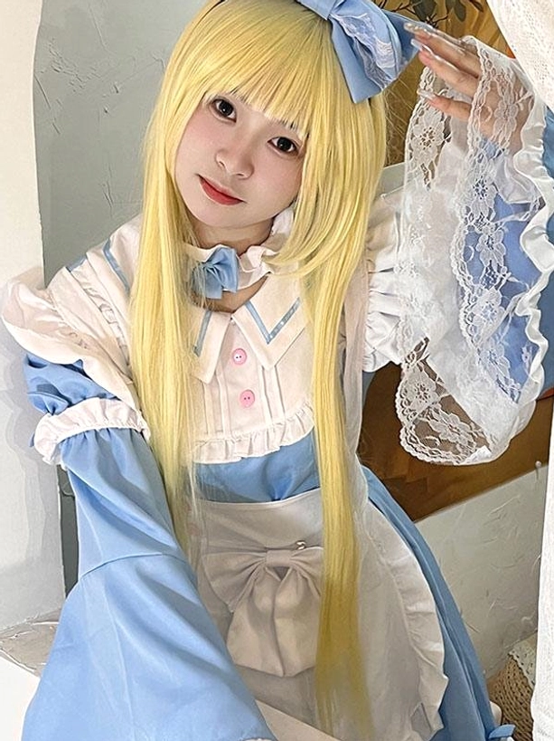 Close-up front view blue maid lolita dress blonde model adjusting blue rose hair bow pink collar buttons lace bell sleeve
