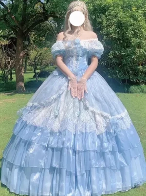 Blue off-shoulder fairy Lolita dress front view with lace-up bodice, short puff sleeves, and voluminous ruffled ball gown skirt on model wearing crown