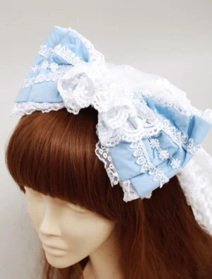 Blue cotton sweet lolita bow headdress with white lace trim displayed on mannequin, three-quarter front view showing layered bow design and floral embroidered details